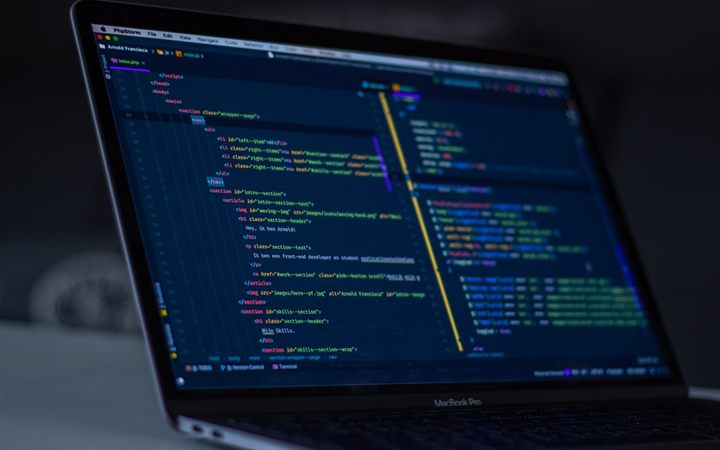 Developer writing custom application code on a laptop